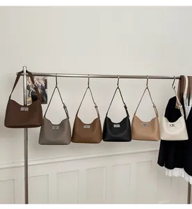 Close-up showing various colors and square metal buckle of the leather hobo bags