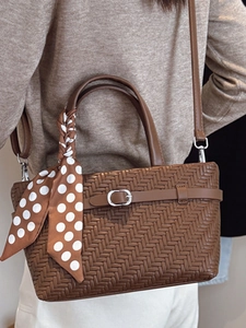 Vintage brown woven leather handbag with polka dot scarf and crossbody strap