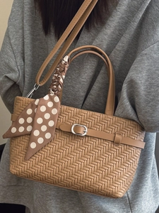 Retro caramel brown woven handbag with silk scarf and silver buckle shown on model