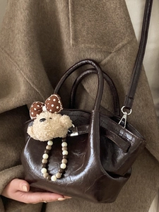 Coffee brown glossy leather bucket bag with cute plush bear charm for autumn winter