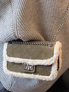 Olive green quilted crossbody bag with white plush trim and silver chain strap