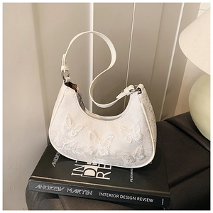 Detailed view of cream lace armpit bag with 3D butterfly floral embroidery