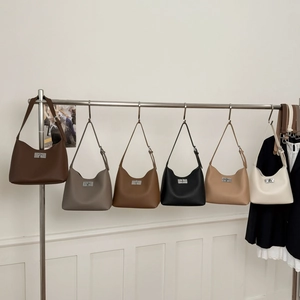 Detailed view showing six diverse colors of minimalist textured leather hobo bags on display