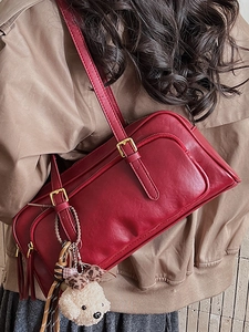 Retro red leather bowling bag with multi-zipper layers and plush dog charm on shoulder strap