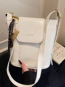 White leather bucket shoulder bag with gold YNGE & VIER text and abacus charm detail
