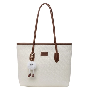 Chic off-white tote bag with brown handles and a cute plush charm accessory for women
