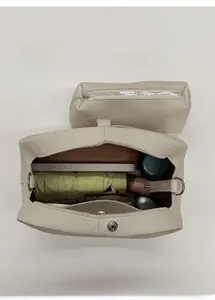 Macro view of vintage beige bucket bag set with inner pouch showing large storage capacity