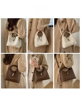 Detail of vintage bucket bags in beige and brown with metal locks and leather texture