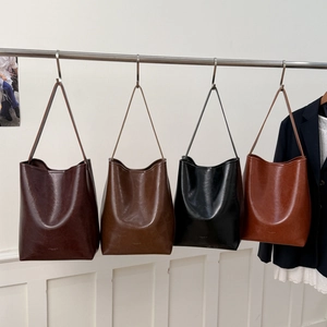 Variety of vintage-style bucket bags in dark coffee, brown, black, and tan faux leather