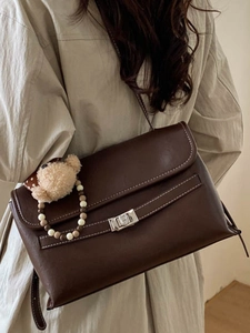 Retro dark brown PU leather crossbody bag with white stitching and plush bear charm