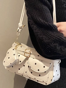 Polka dot mini handbag with heart charm and double front pockets on white shoulder strap