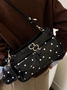 Polka dot black patent leather mini crossbody bag with heart charm and gold hardware