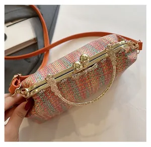 Détail du sac à main tissé coloré avec ferrures dorées et poignée fleurie en cristal
