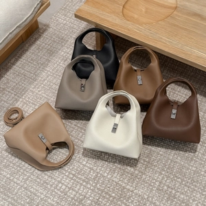Detailed collection of vintage leather bucket bags in multiple classic colors on textured rug