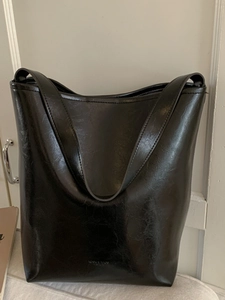 Glossy black faux leather bucket tote bag with vintage minimalist vertical design