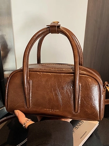 Sac bowling vintage en cuir ciré marron avec poignée et logo doré imprimé