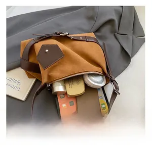 Détail montrant l'intérieur spacieux du sac cabas marron vintage avec objets du quotidien