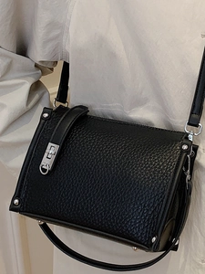 Minimalist black lychee leather crossbody square handbag with silver twist lock and strap