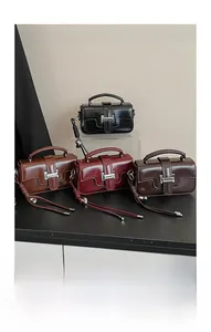 Detailed display of four vintage glossy leather shoulder bags in various classic colors