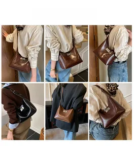 Detail view of stylish crossbody bucket bags in dark brown, black, and caramel faux leather