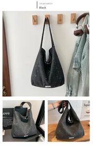 Macro shot of large black tote bag with white star pattern and wide integrated strap