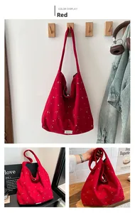 Detailed views of red canvas tote bag with white star pattern for daily commute