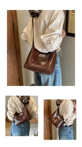 Detail of deep brown glossy shoulder bag featuring a silver twist lock and spacious base