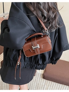 Brown rectangular crossbody bag shown on a model for lifestyle scale and size