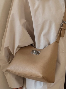 Minimalist camel leather shoulder bag with silver turn-lock buckle and pebbled texture