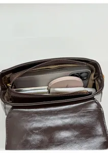 Top view of the deep brown leather bag showing spacious interior with daily essentials