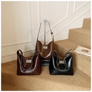 Detailed trio of sleek oil-wax leather bucket bags in black, tan and deep brown colors
