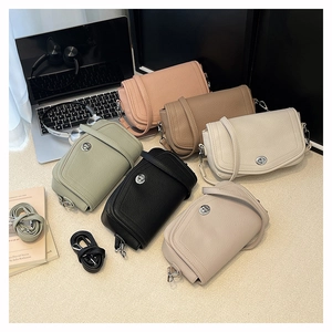 Detail showing six colors of litchi grain leather bags with metal turn-lock closures