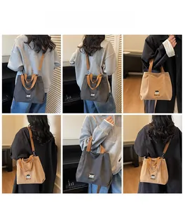 Detail view of embroidered canvas tote bag with adjustable straps in gray and khaki colors