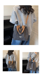 Detail of grey canvas tote bag with Doodlegirl embroidery and brown shoulder strap