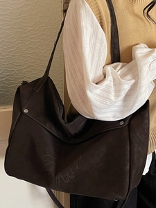 Brown large capacity tote bag with embossed daisy pattern for women's daily commute