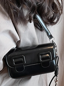 Glossy black patent leather saddle bag with double square buckles and silver hardware