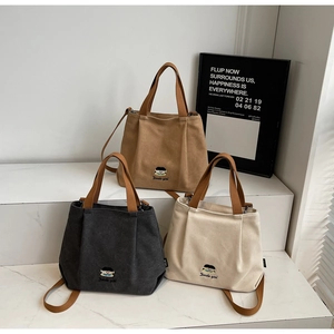 Detailed embroidery and minimalist canvas texture in brown, grey, and beige bag options