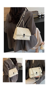 Detail view of cream quilted crossbody bag with V-shaped stitching and chain strap