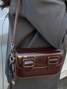 2025 Trendy dark brown glossy leather saddle bag with vintage buckles and crossbody strap