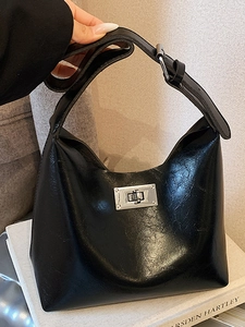Minimalist black leather hobo bag with vintage texture and silver twist lock detail