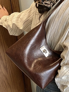 Minimalist vintage dark brown shoulder bag with silver turn-lock and polished texture