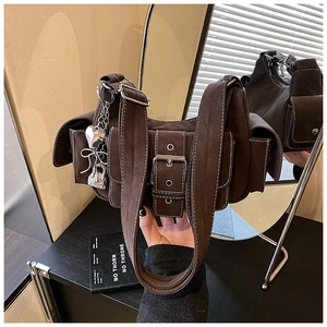 Close-up of retro brown crossbody bag with matte texture and Y2K metal charms