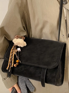 Retro black crossbody bag with suede texture and cute teddy bear charm accessory