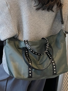 Army green large tote bag with silver studs and black leather trim for daily commute