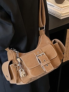 Retro brown suede shoulder bag with silver buckle and Y2K charms for 2025 winter style