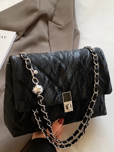 Chic black pleated shoulder bag with large diamond stitching and silver ball chain strap