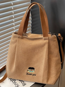 Brown canvas tote bag with girl embroidery and adjustable strap for daily commute