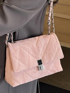 Chic pink quilted shoulder bag with silver chain strap and modern turn-lock closure