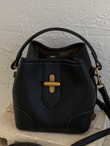 Chic black litchi leather bucket bag with metal twist lock and round top handle