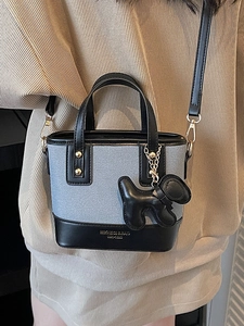 Chic blue textured mini tote bucket bag with leather trim and puppy charm detail